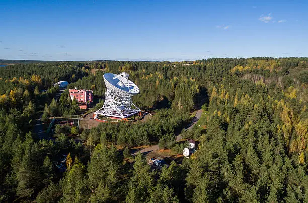 Aerial view radio telescope in forest at countryside in saint-Petersburg Russia