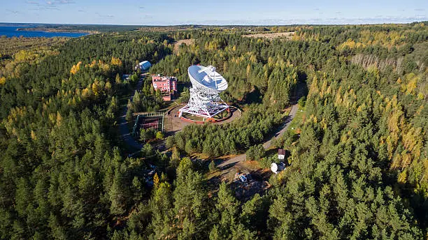 Aerial view radio telescope in forest at countryside in saint-Petersburg Russia