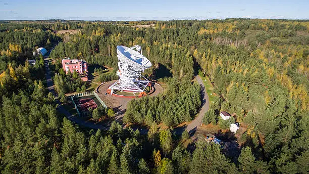 Aerial view radio telescope in forest at countryside in saint-Petersburg Russia