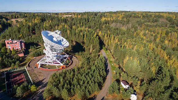 Aerial view radio telescope in forest at countryside in saint-Petersburg Russia