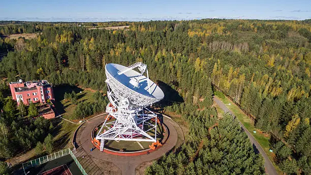 Aerial view radio telescope in forest at countryside in saint-Petersburg Russia