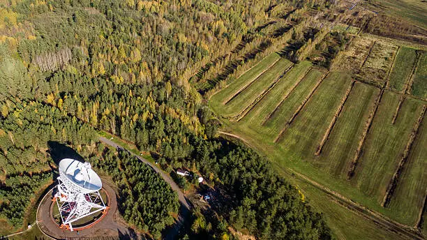 Aerial view radio telescope in forest at countryside in saint-Petersburg Russia
