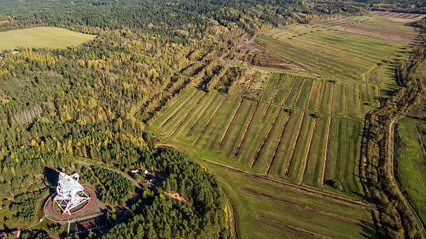 Aerial view radio telescope in forest at countryside in saint-Petersburg Russia