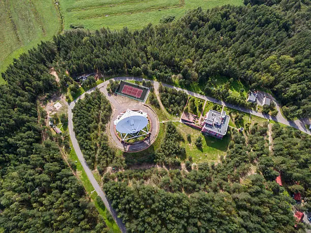 Aerial view radio telescope in forest at countryside in saint-Petersburg Russia