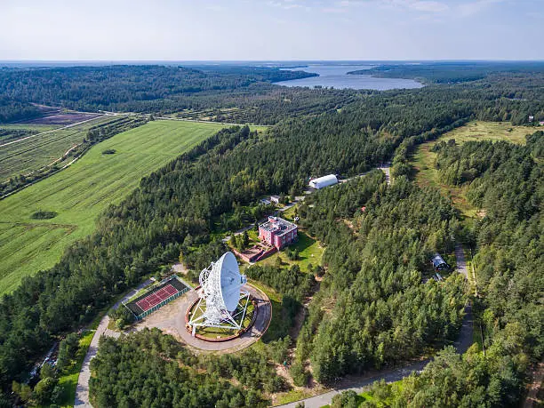 Aerial view radio telescope in forest at countryside in saint-Petersburg Russia