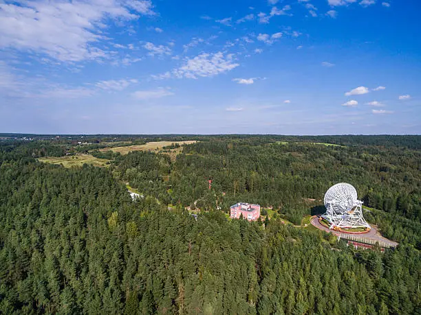 Aerial view radio telescope in forest at countryside in saint-Petersburg Russia