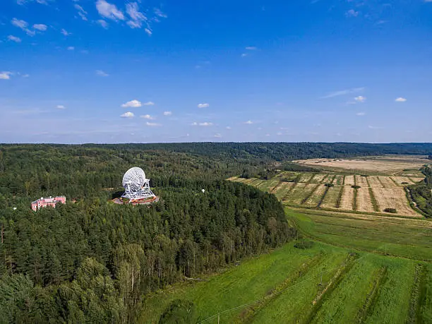 Aerial view radio telescope in forest at countryside in saint-Petersburg Russia