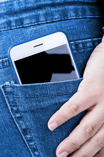 istock White phone in jeans back pocket 597236892