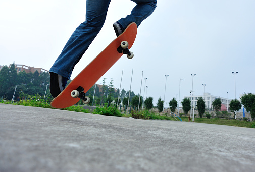 skateboarder legs riding on a skateboard