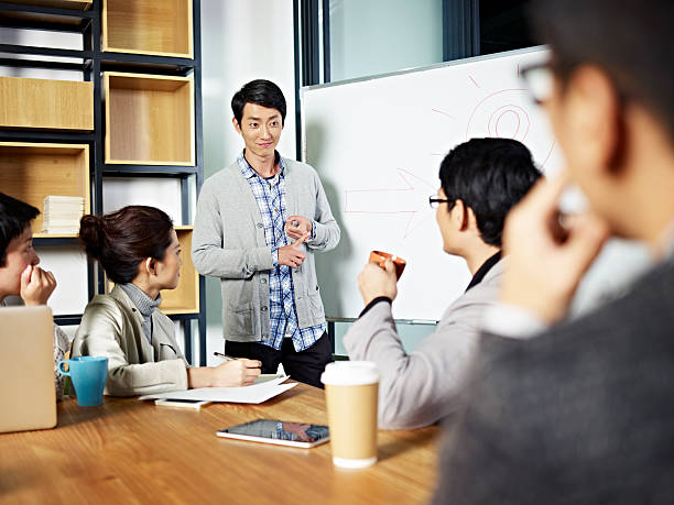 young asian businessman facilitating a discussion