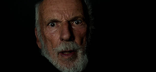 istock Startled Old Guy, Low-Key Grunge Lighting, Senior Man, Gothic Style 597240184