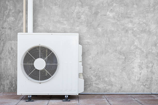 istock New air conditioning compressor near the wall 597242208