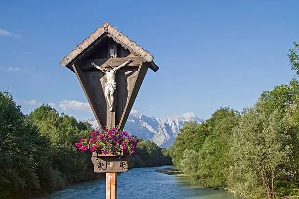 Wetterstein view with wooden crucifix on the Loisach bridge in Oberau