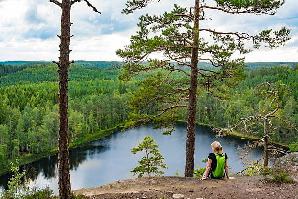 istock Woman looking at view on high cliff 597245574