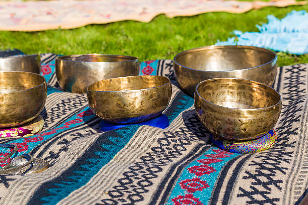 istock Singing bowls for massage in a row on grass 597246384