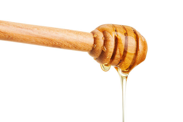 istock Honey dripping isolated on white with clipping path 597246650