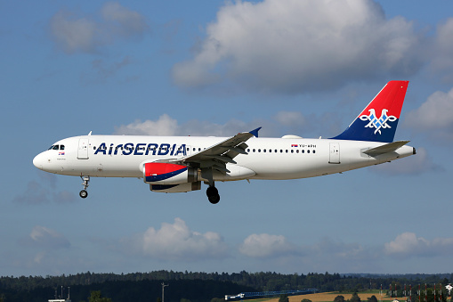 Zurich, Switzerland - July 29, 2016: An Air Serbia Airbus A320 with the registration YU-APH landing at Zurich Airport (ZRH) in Switzerland. Air Serbia is the flag carrier airline of Serbia with its headquarters in Belgrade.