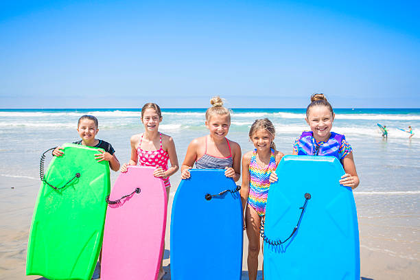 istock Kids playing at the beach together while on vacation 597250494