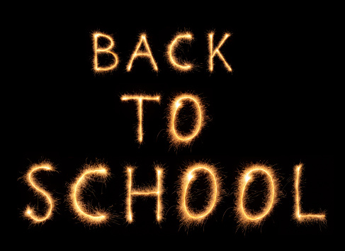Back to school lettering drawn with bengali sparkles isolated on black background