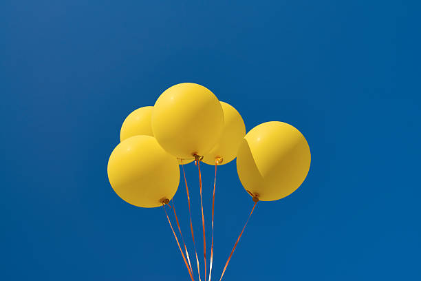 istock Balloons Flying Up in Sky 597252344