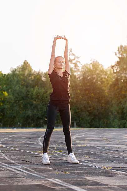 istock Young cute girl warming up before workout 597253192