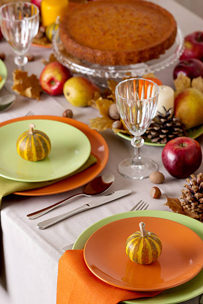 istock Thanksgiving dinner. Seasonal table setting with autumn leaves, 597253378