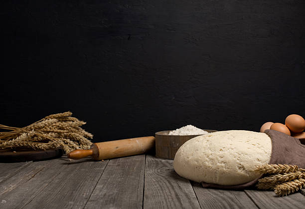 istock Dough on wooden table with ingredients for the making dough 597255034