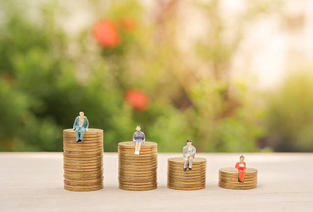 istock Business miniature people and money stack gold coin 597256454