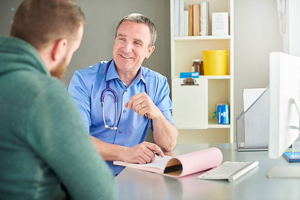 istock doctor laughing with patient 597256532