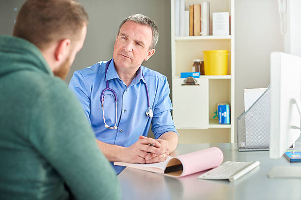 istock doctor listening to patient 597256602