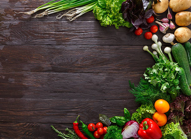 istock Frame of fresh vegetables on wooden background with copy space 597258472