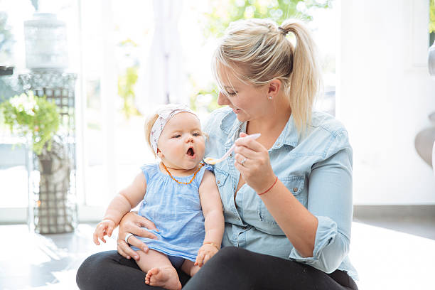istock Mom feeding her Baby 597258516
