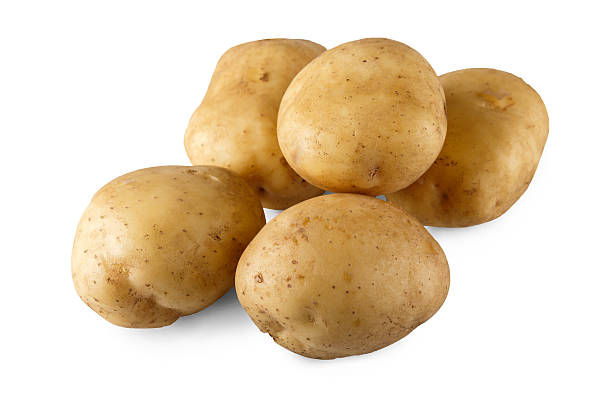 istock Stack of raw potatoes closeup isolated on white background 597258976