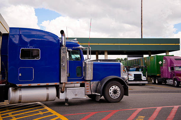 istock Blue semi truck rig on truck stop side view 597259656