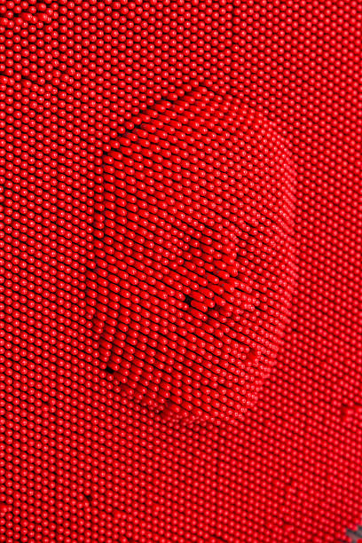 istock Face pressed to red pin art board 597260352