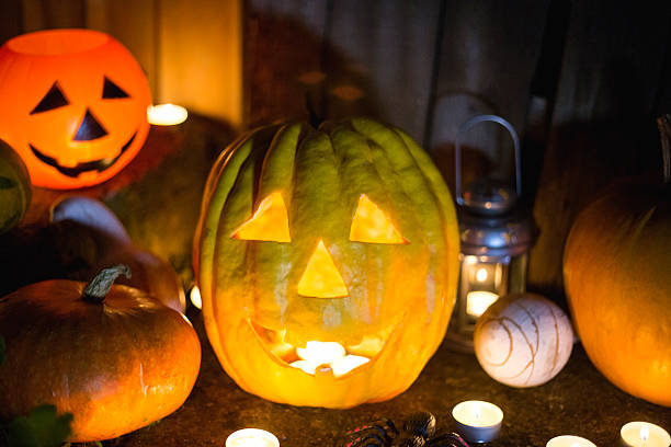 istock Halloween pumpkin head jack lantern on wooden background 597260666