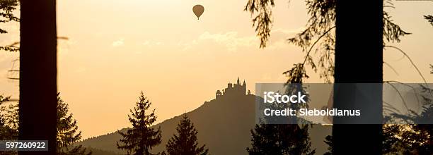 Hohenzollern Castle Silhouette And Hotairballoon At Sunset Seen Through Forestforeground Stock Photo - Download Image Now