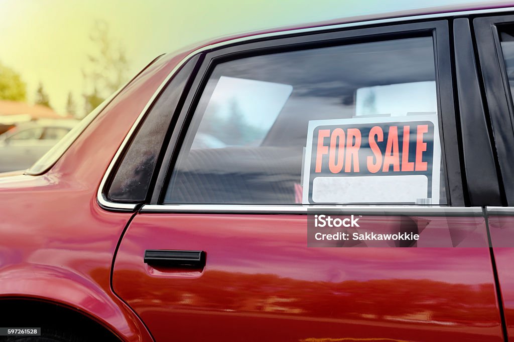 shiny car for sale in summer weather shiny car for sale in summer weather, parked with a red vibrant color exterior. Car Stock Photo