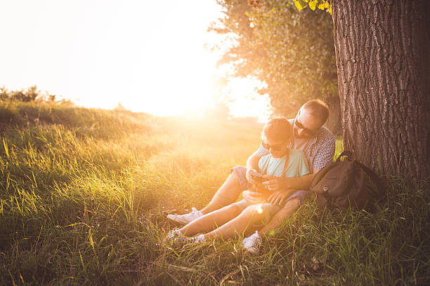 istock Father and son checking previews on camera in nature 597265422