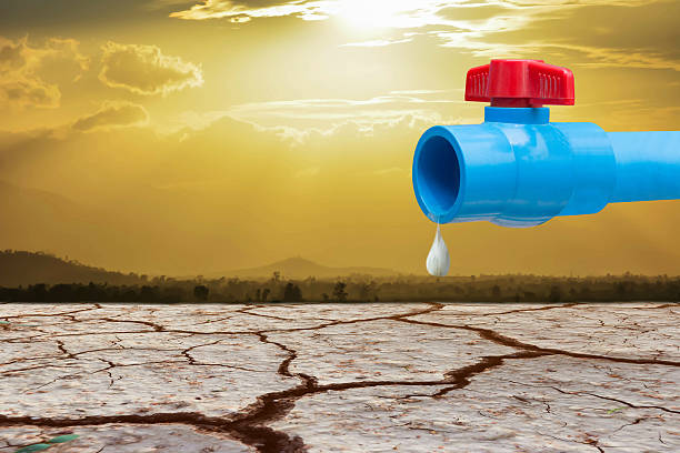 istock pipe and valve against waterless cracked soil 597265954