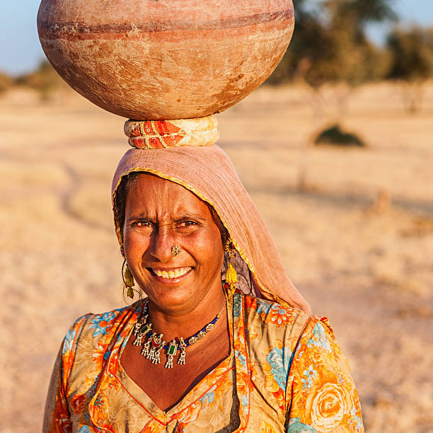 istock Indian woman carrying water, Rajasthan 597266030
