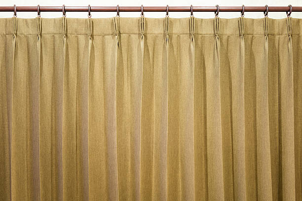 istock Brown curtains hang on the curtain rail. 597266630