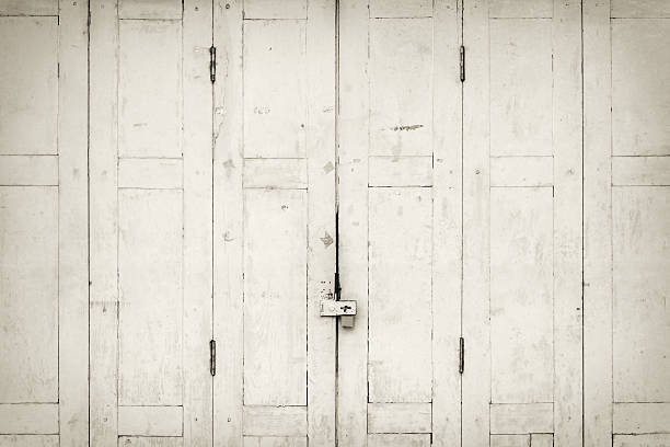 istock The old grunge folding door closed in B&W. 597267114