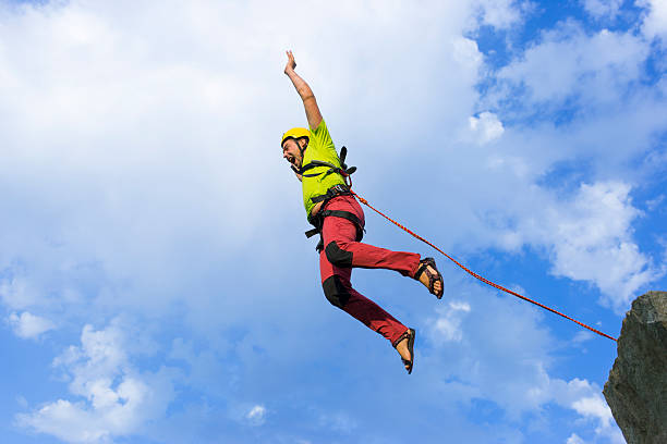 istock Jump rope from a high rock in the mountains. 597267484