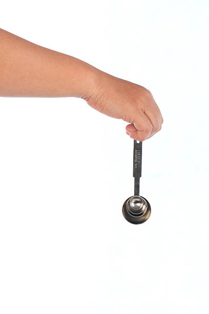 istock Steel measuring spoons on white background 597268402