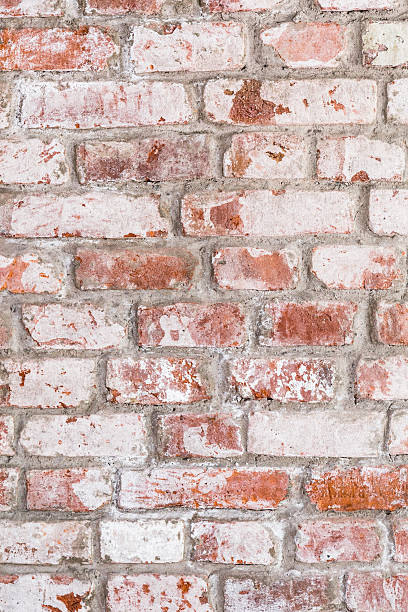 istock Texture of old rustic brick wall painted with white 597268964
