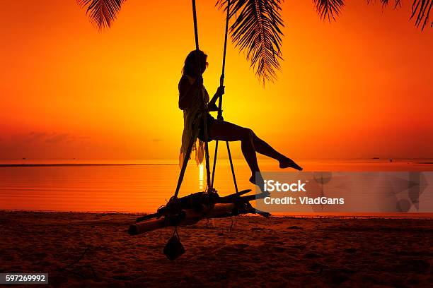 Woman Sitting At Tropical Swing Stock Photo - Download Image Now - Activity, Adult, Adults Only