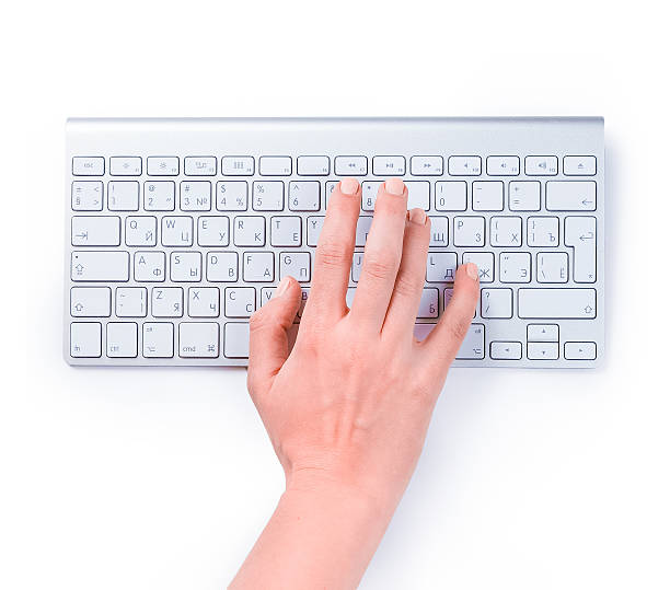 istock Typing femle hand on keyboard isolated over white 597270828