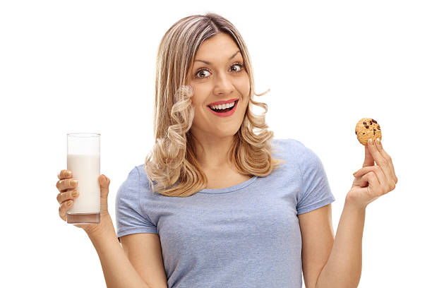 istock Woman holding a cookie and milk 597270992