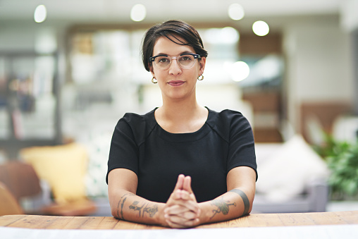 Cropped portrait of a young businesswoman sitting at her desk in her office